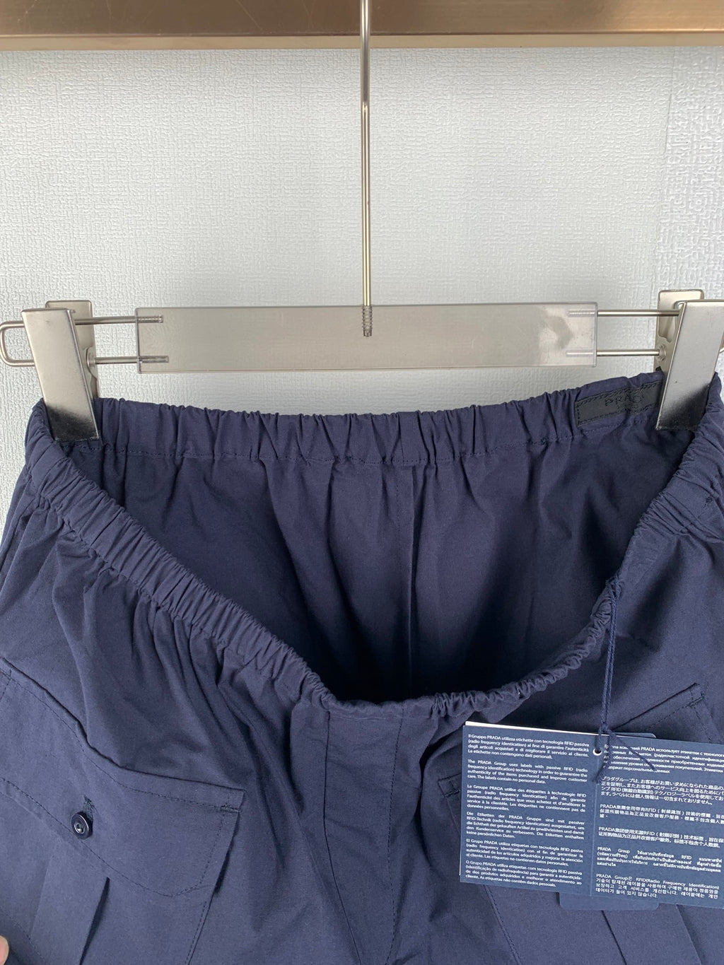 Navy Prada shorts with elastic waist and visible interior panel