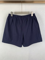 Navy Prada shorts with elastic waist and full front view