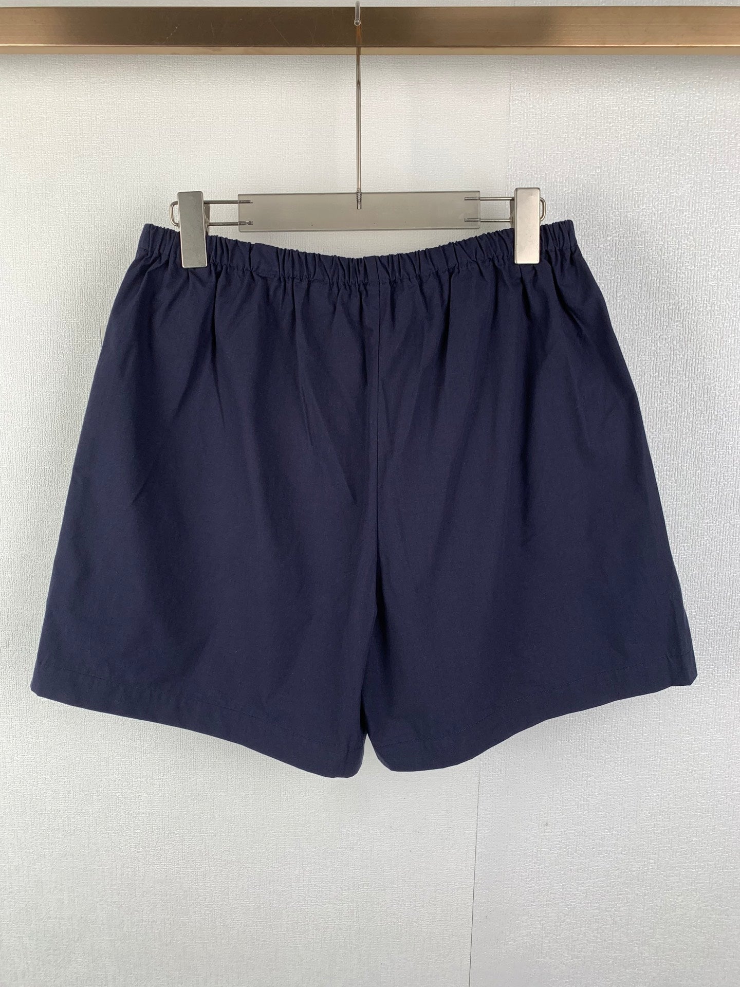 Navy Prada shorts with elastic waist and full front view