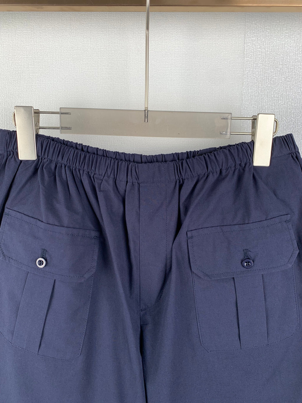 Navy Prada shorts with elastic waistband and button cargo pockets