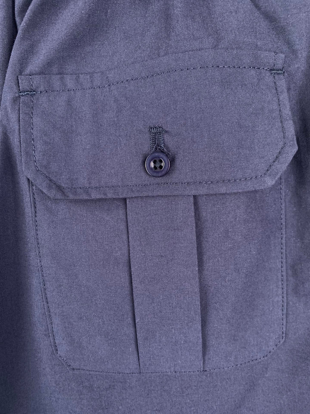 Navy Prada shorts with flap pocket and round button closure