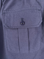 Navy Prada shorts with flap pocket and round button closure