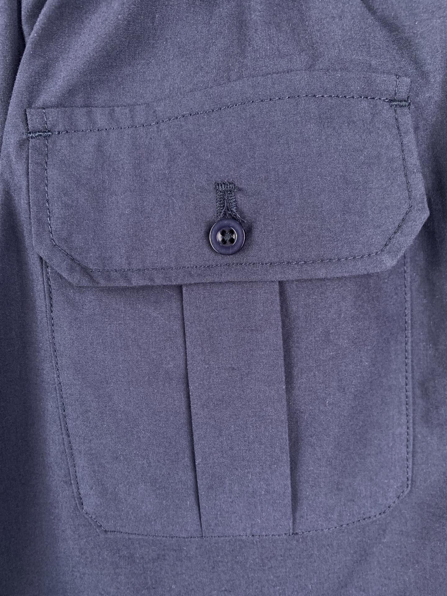 Navy Prada shorts with flap pocket and round button closure