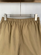 Olive shorts showing elastic waistband with gathered top and front patch pockets