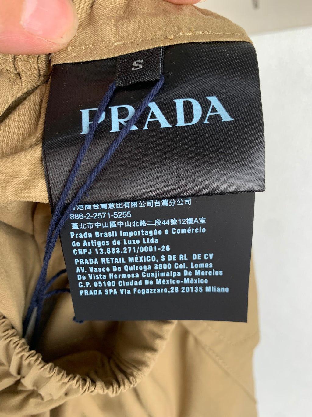 Prada garment label on olive shorts waistband