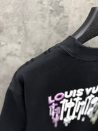 Black T-shirt shoulder with partial LOUIS VUITTON drip graphic