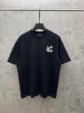 Black T-shirt with small multicolor graphic emblem on chest