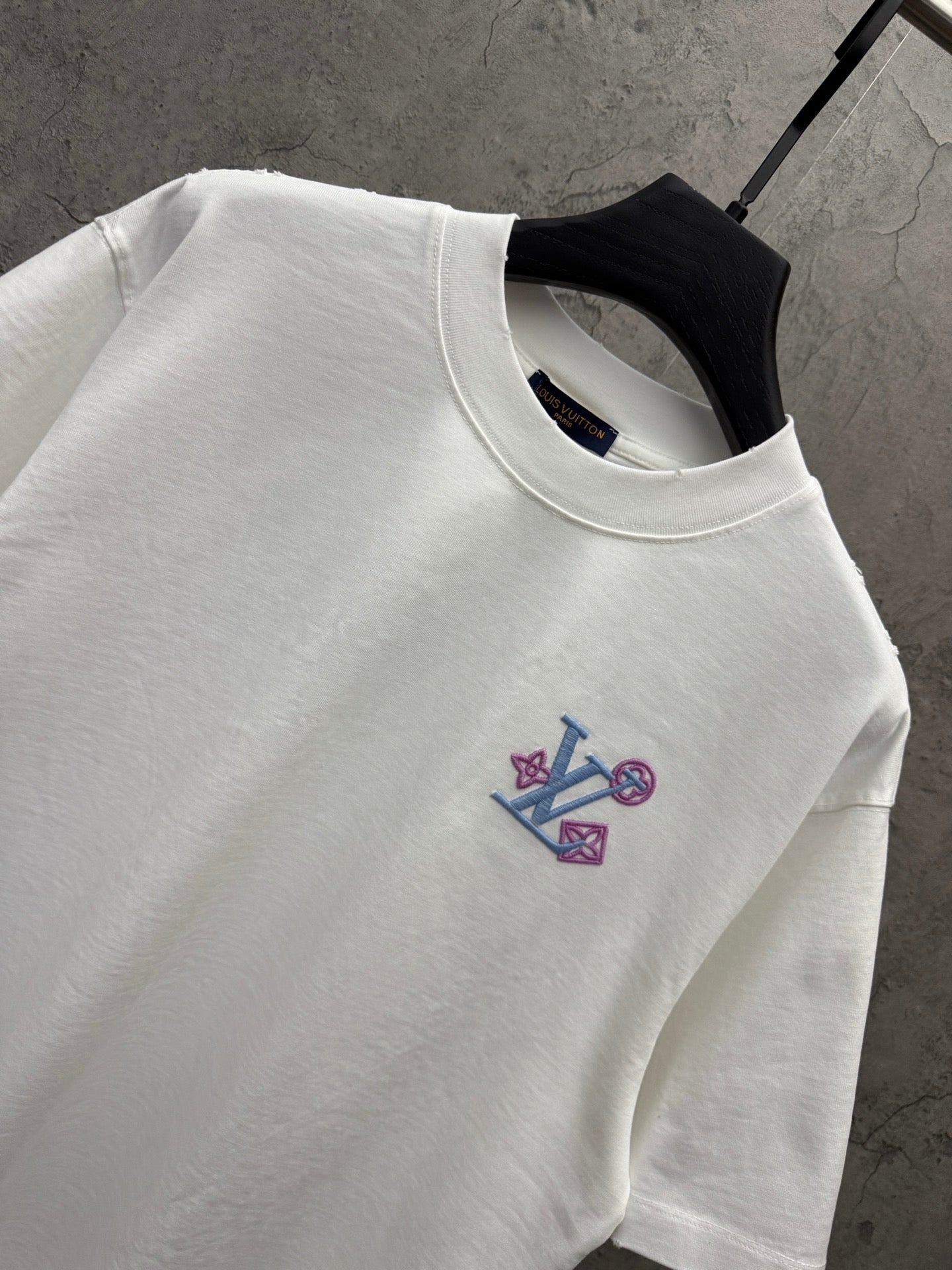 White T-shirt neckline with embroidered Louis Vuitton emblem