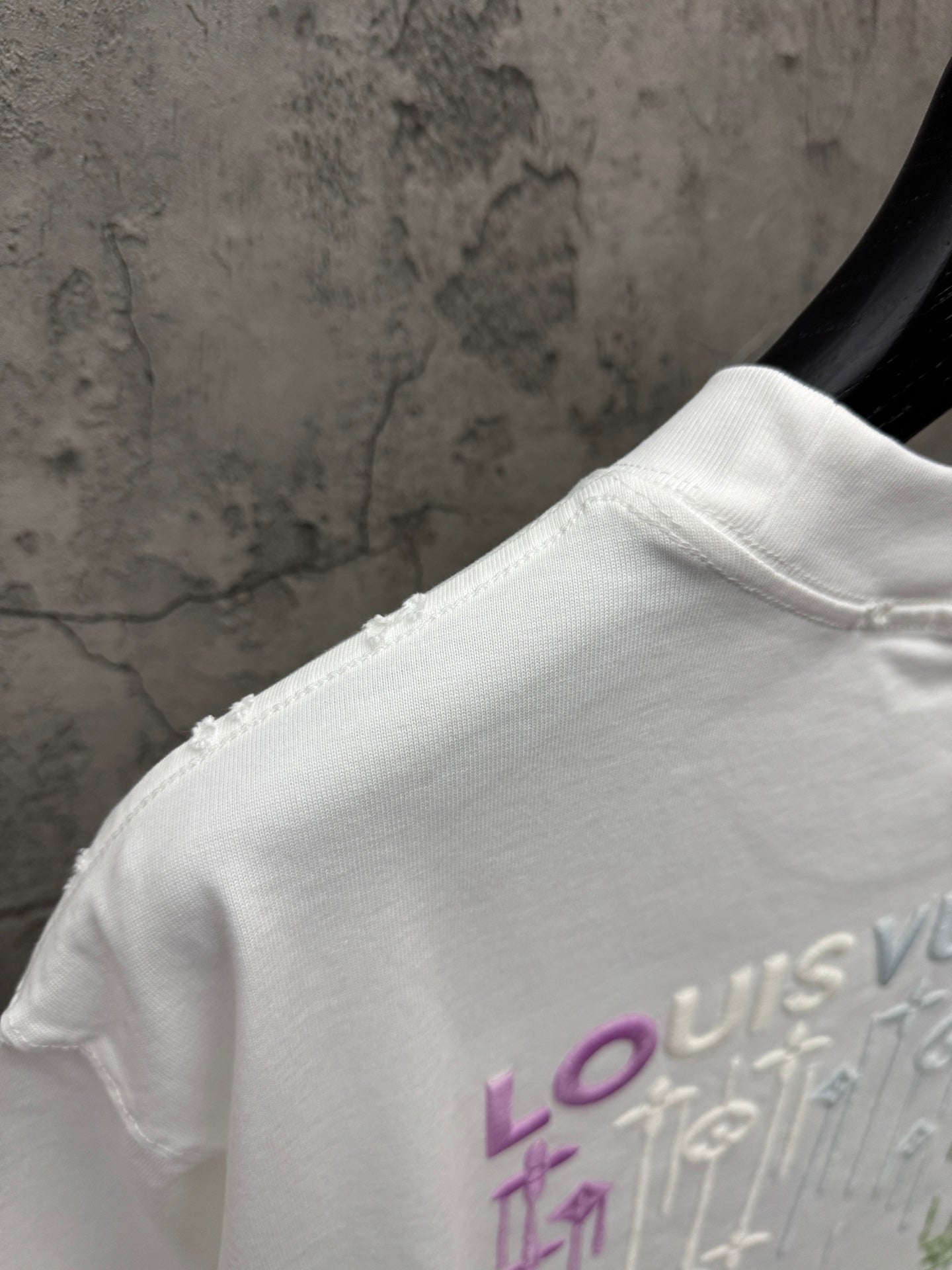 White T-shirt shoulder and collar with partial Louis Vuitton back print