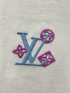 Embroidered Louis Vuitton-style logo on white fabric, blue and purple
