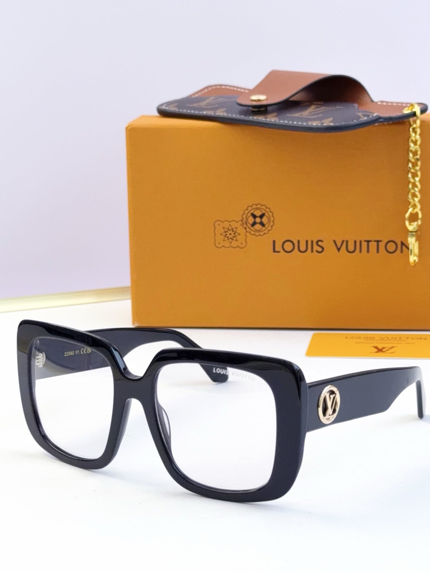 Louis Vuitton sunglasses, clear lenses, black and navy frame with gold logo accents