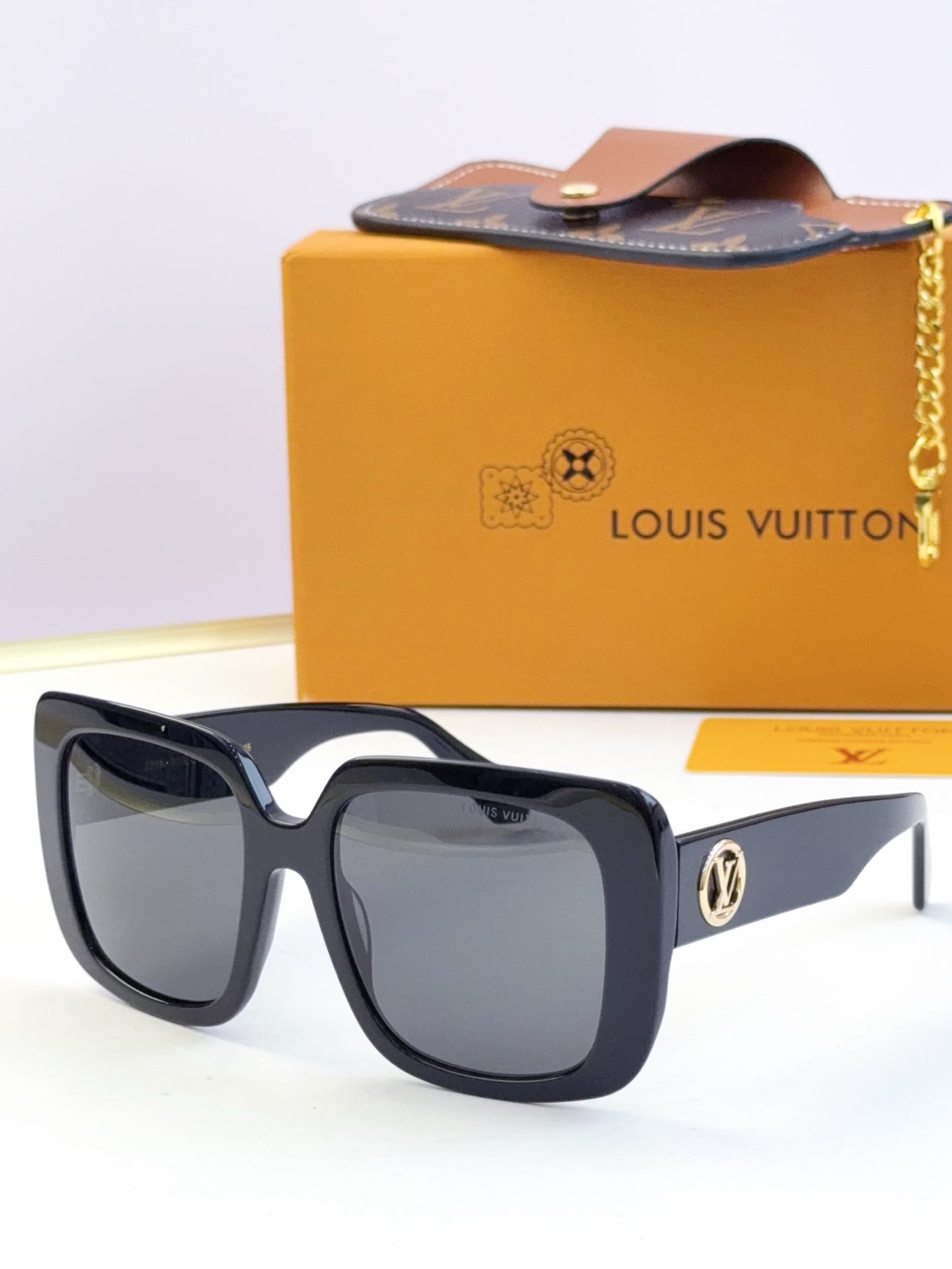 Louis Vuitton sunglasses, dark gray lenses, black and navy frame with gold logo detail