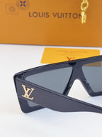 Louis Vuitton dark blue sunglasses with tinted lenses and gold LV logo on side.