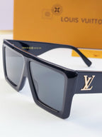 Louis Vuitton black sunglasses with dark lenses and gold LV logo on temple.