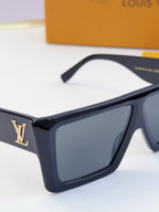 Louis Vuitton black square sunglasses with dark lenses and gold LV logo on side.