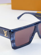 Louis Vuitton blue sunglasses with tinted lenses and gold LV logo on side.