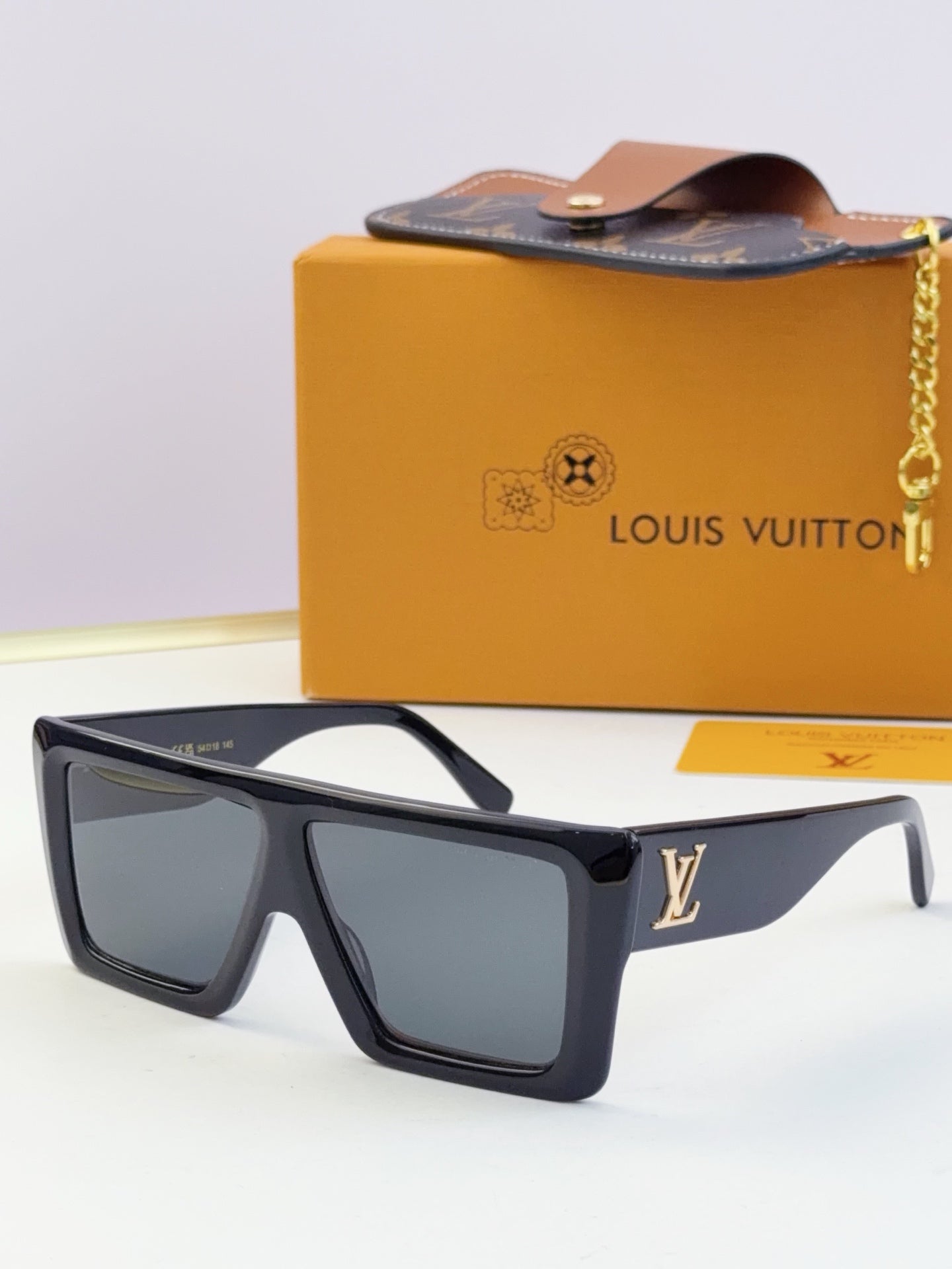 Louis Vuitton blue sunglasses with dark lenses and gold LV logo on temple.