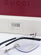 Gucci eyeglasses close-up, clear lenses with metal frame, temples with multicolor stripe detail
