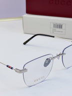 Gucci eyeglasses close-up, clear lenses with metal frame and black temple, multicolor stripe detail