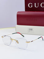 Gucci eyeglasses with clear lenses, gold-tone metal frame, black temples with multicolor stripe and red accent