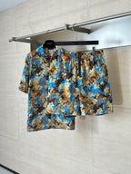 Gucci patterned shorts with elastic waistband, blue and brown all-over print.