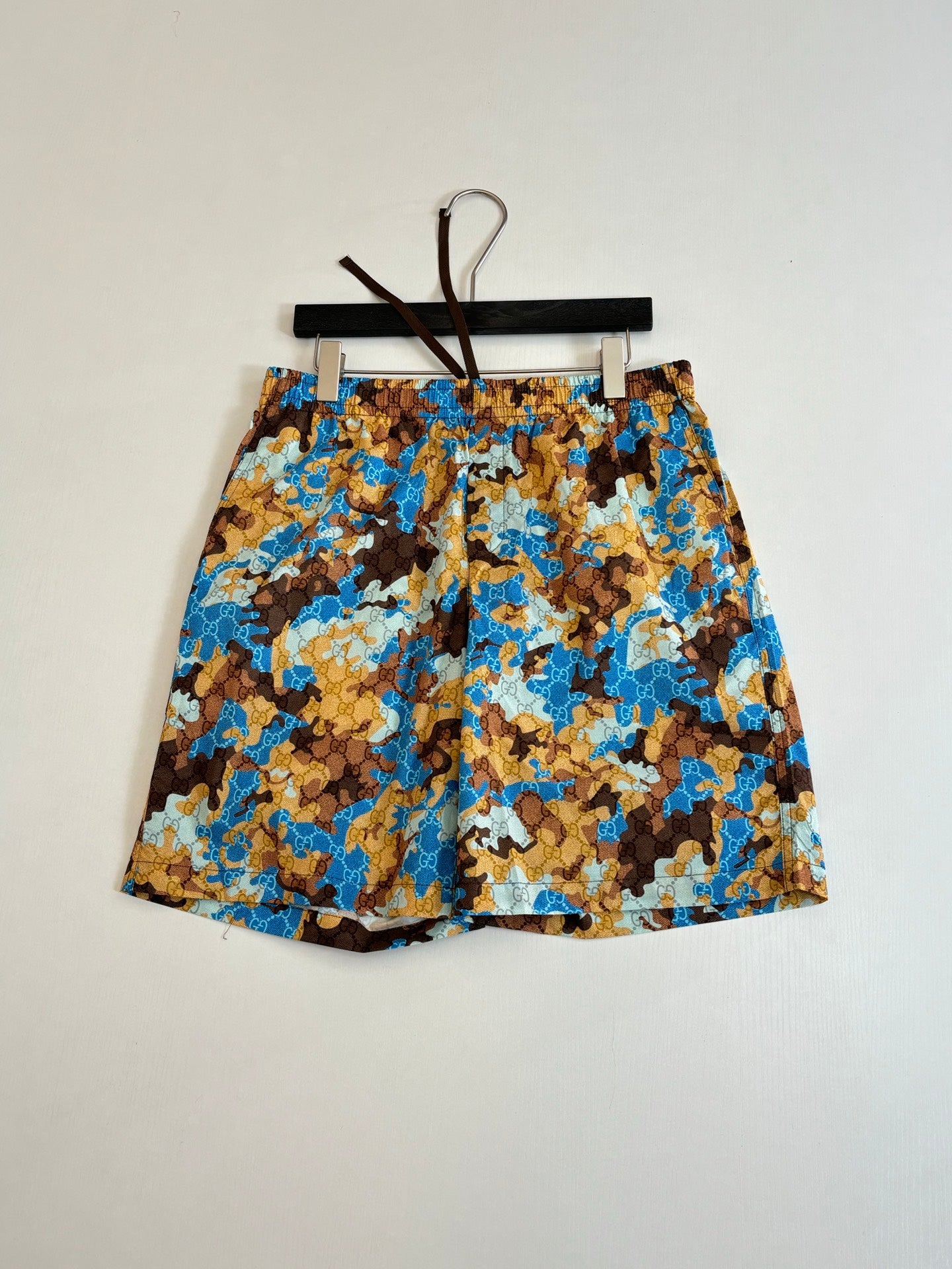 Gucci patterned shorts with elastic waistband, blue and brown all-over print.