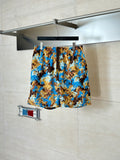 Gucci patterned shorts in blue and brown, all-over design on display.