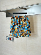 Gucci patterned shorts in blue and brown, all-over design on display.