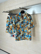Short-sleeve button-up shirt on hanger, full view of blue and tan abstract pattern