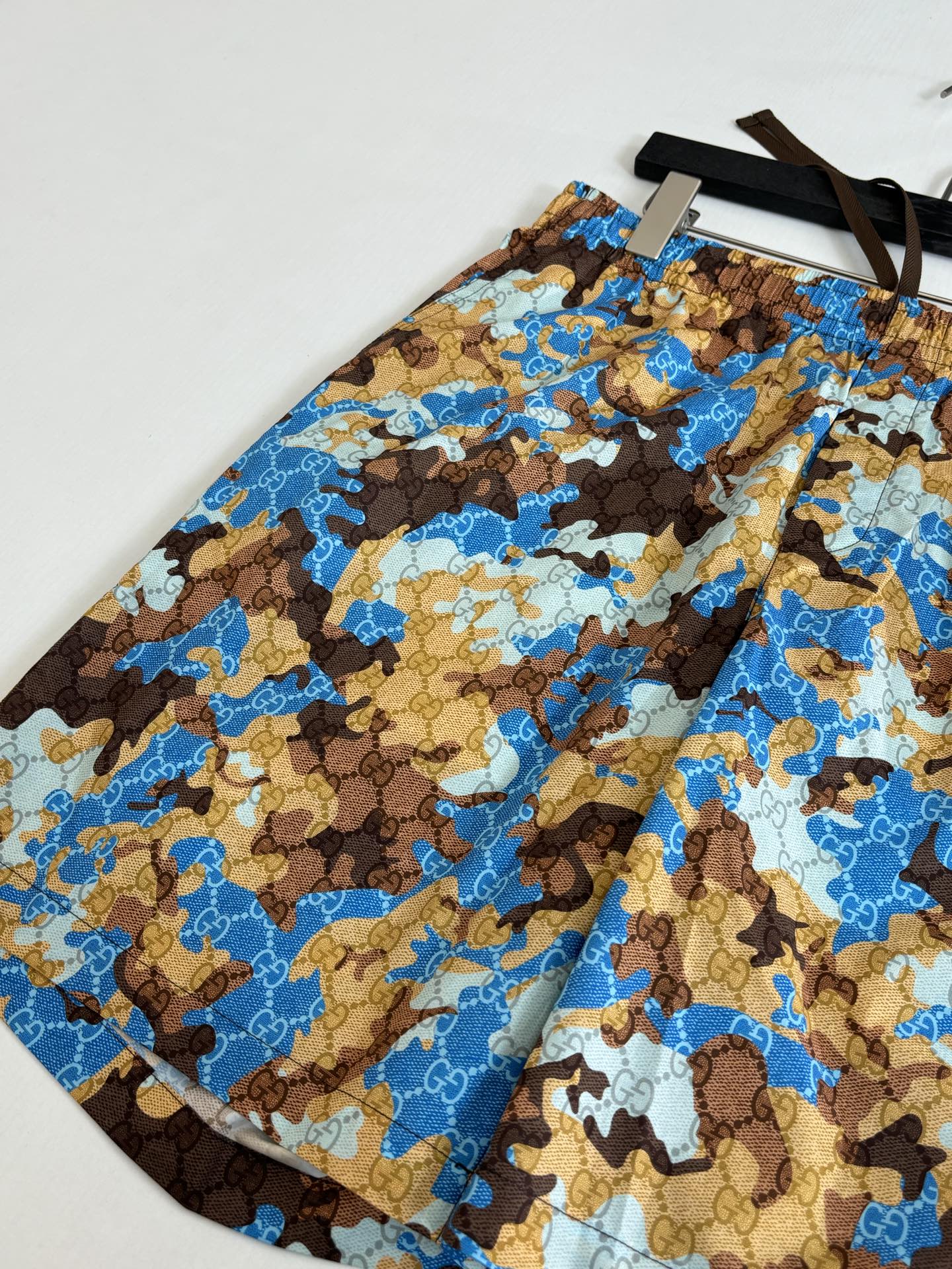 Gucci shorts with elastic waistband, blue and brown all-over print pattern.