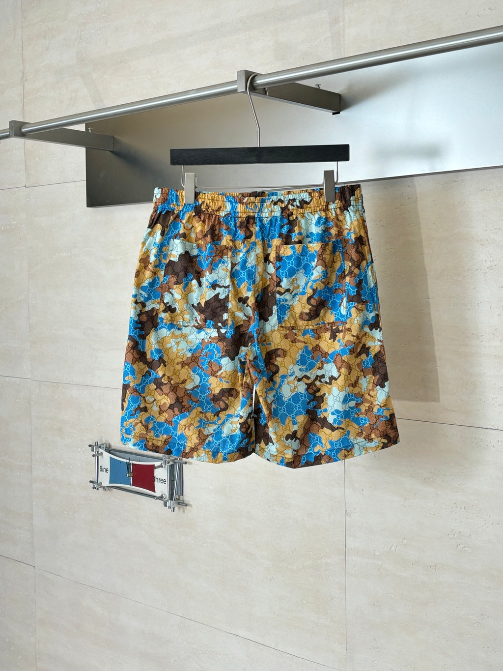 Gucci patterned shorts with elastic waistband, blue and brown all-over print.
