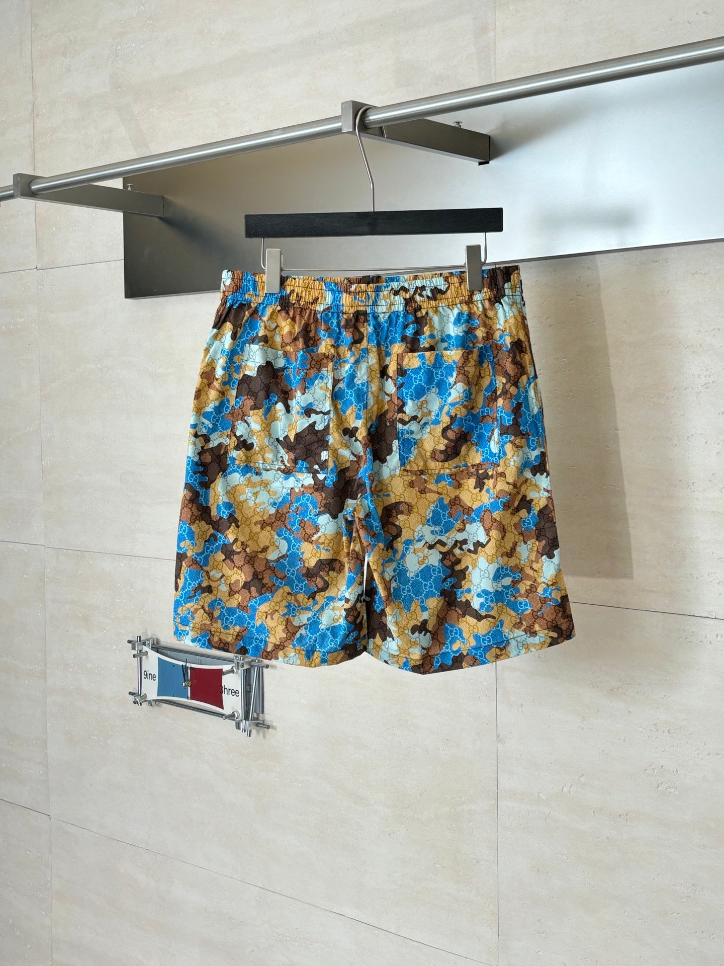Gucci patterned shorts with elastic waistband, blue and brown all-over print.