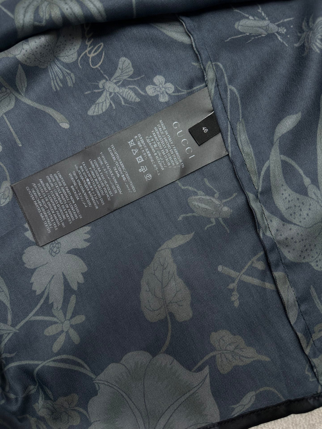 Long-sleeve button-up shirt interior care label with floral fabric