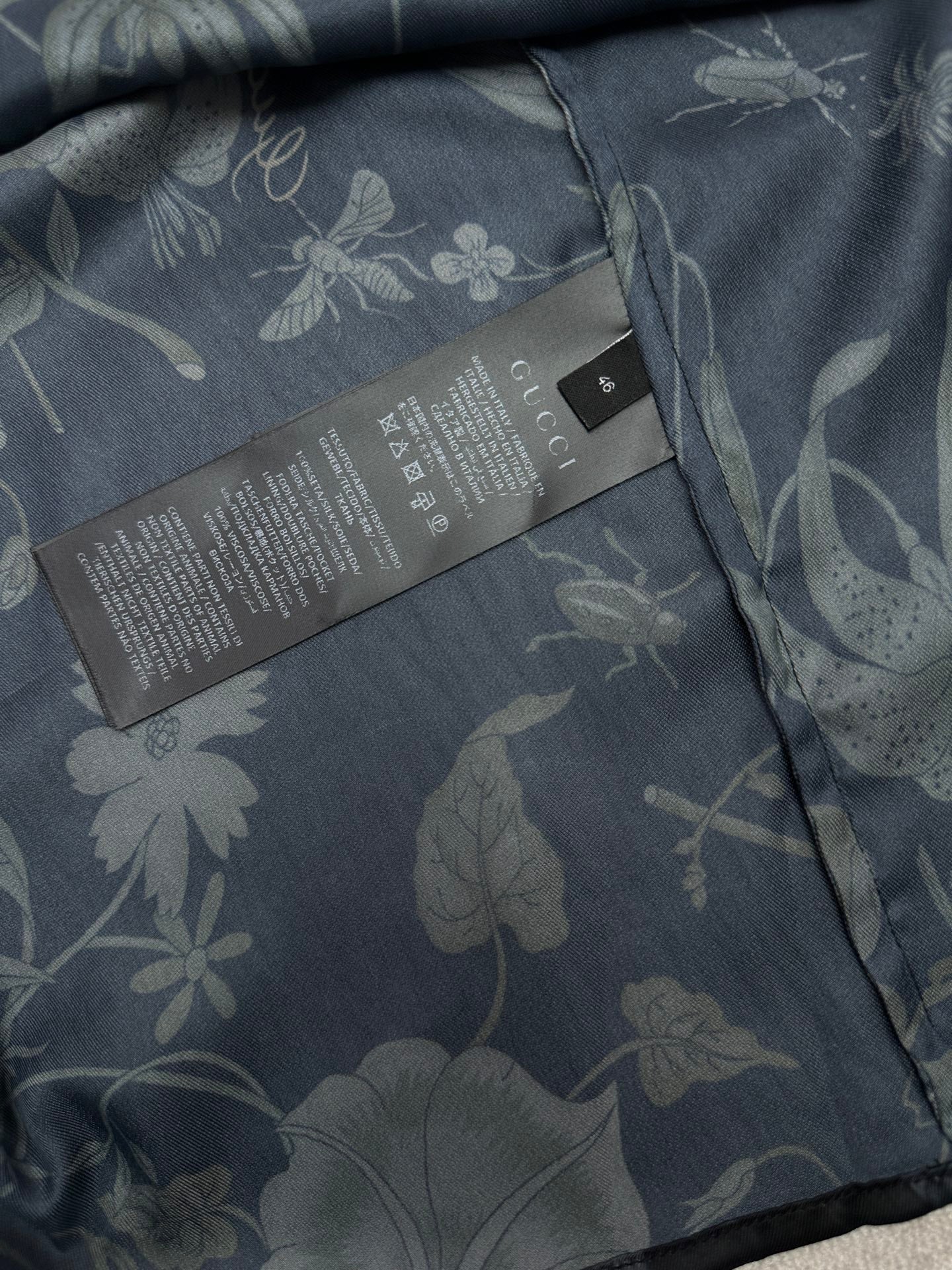 Long-sleeve button-up shirt interior care label with floral fabric