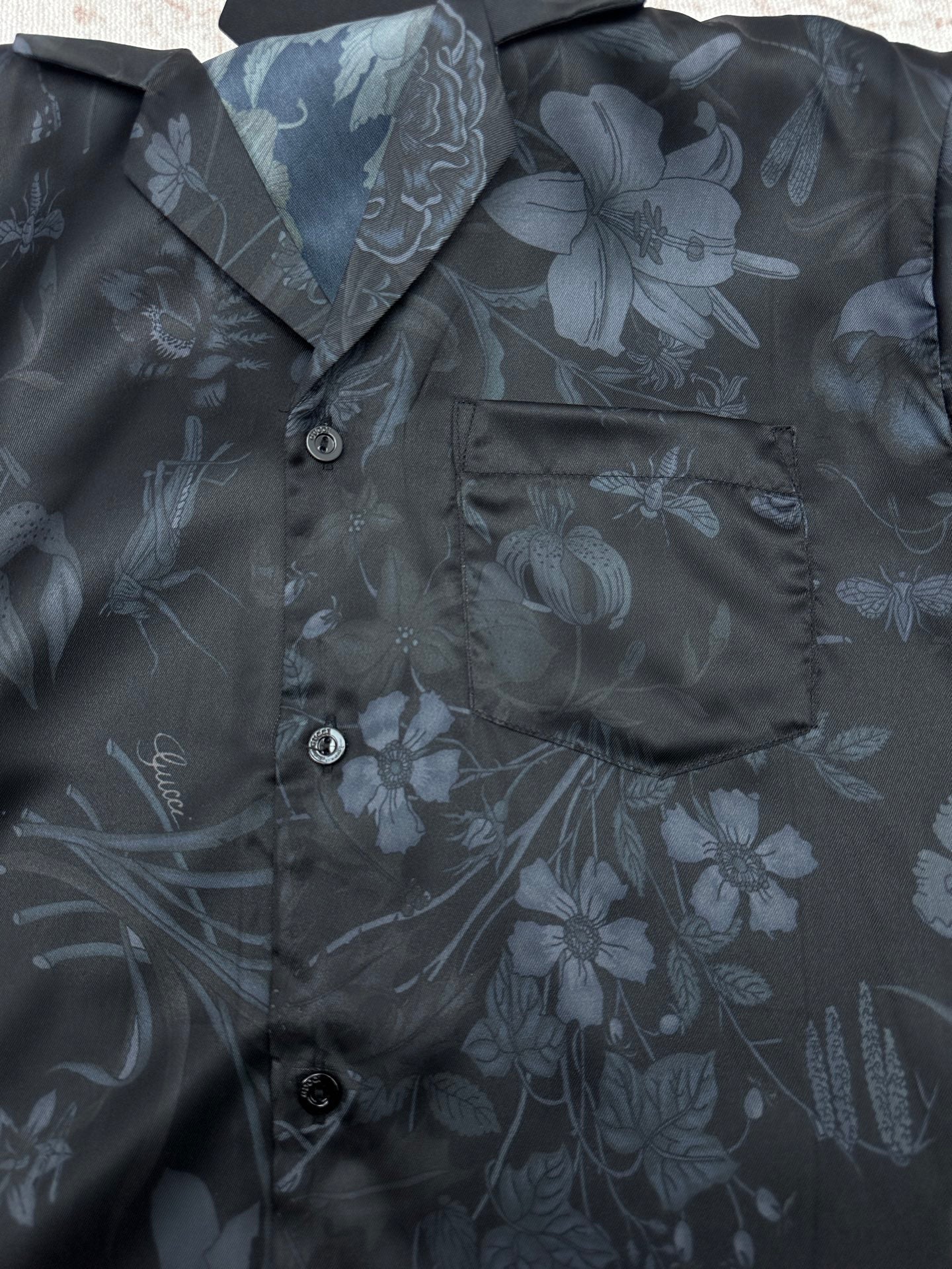 Long-sleeve button-up shirt front with buttons and chest pocket, floral print