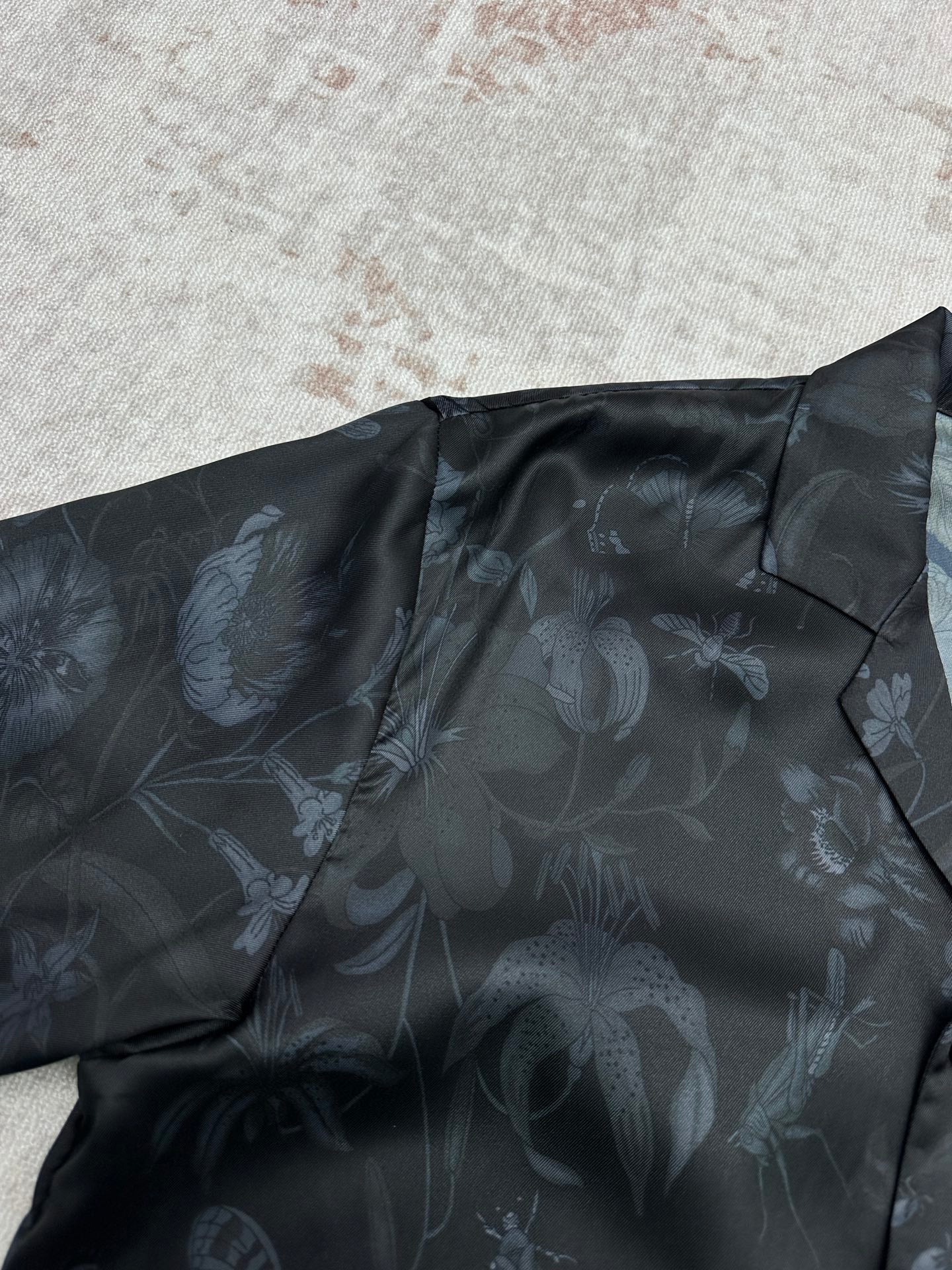 Long-sleeve button-up shirt shoulder area with allover light floral print