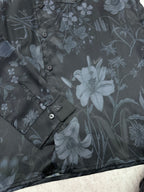 Long-sleeve button-up shirt fabric texture with floral pattern and buttons