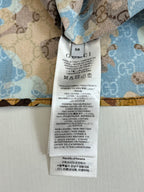 Gucci short with stitched care label on light blue patterned fabric
