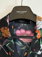 Collar close-up on black shirt with pink floral print