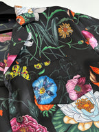 Black shirt fabric detail with colorful flowers and insects pattern