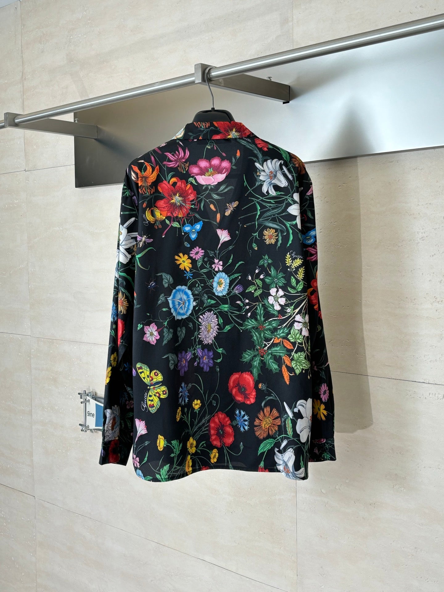 Long-sleeve shirt with colorful garden print on a dark background