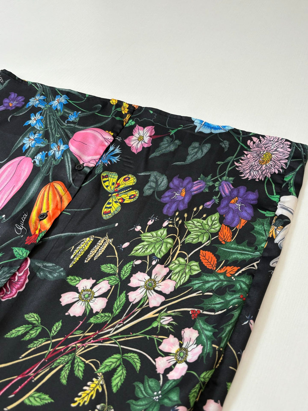 Shirt hem close-up with multicolor floral and butterfly pattern