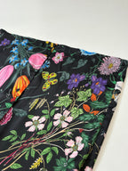 Shirt hem close-up with multicolor floral and butterfly pattern