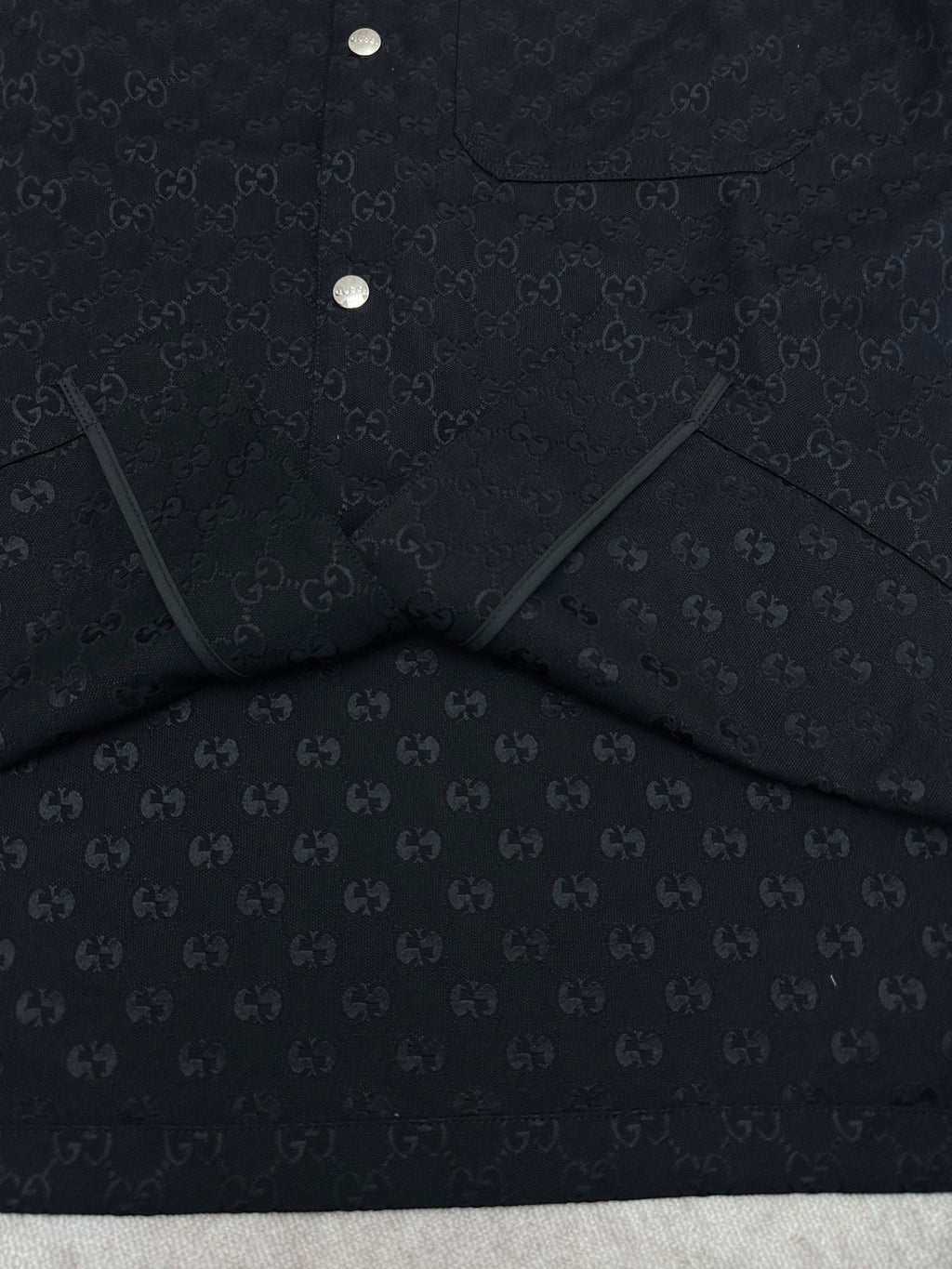 Dark navy short-sleeve shirt, folded view with inner label panel