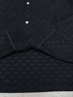 Dark navy short-sleeve shirt, folded view with inner label panel