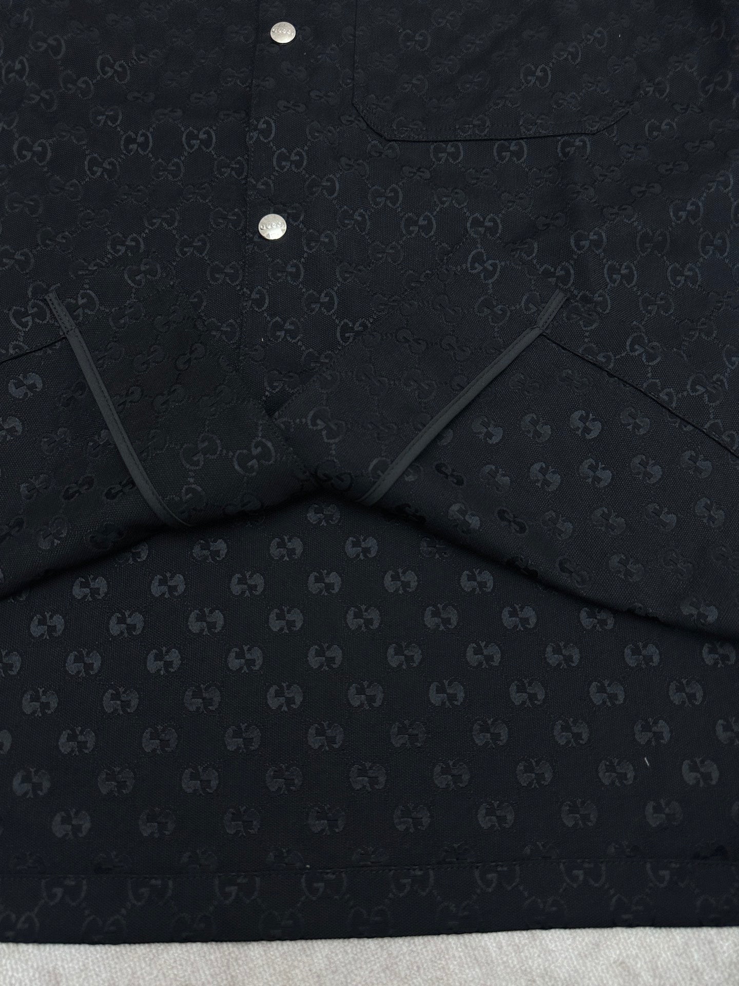 Dark navy short-sleeve shirt, folded view with inner label panel