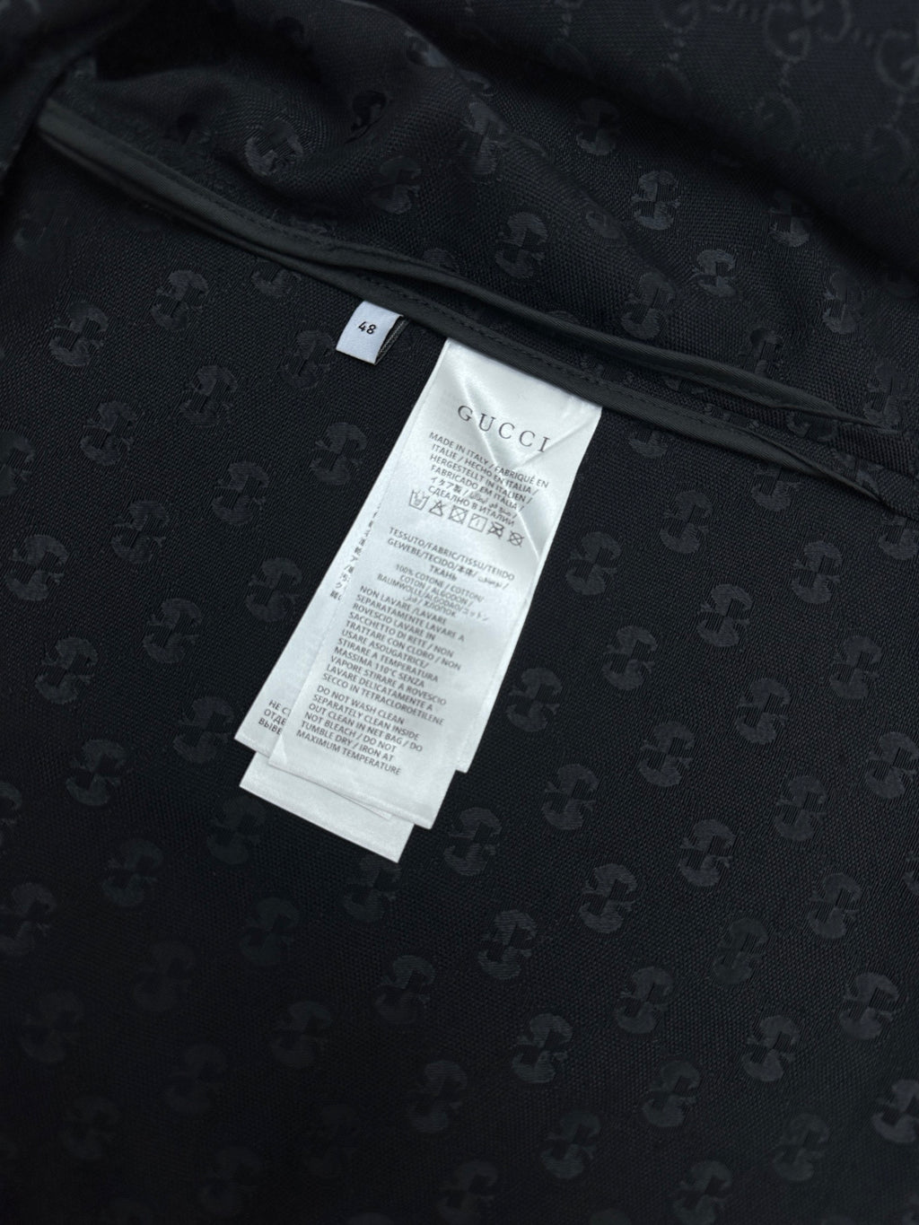 Dark navy short-sleeve shirt, neckline with size and care labels inside