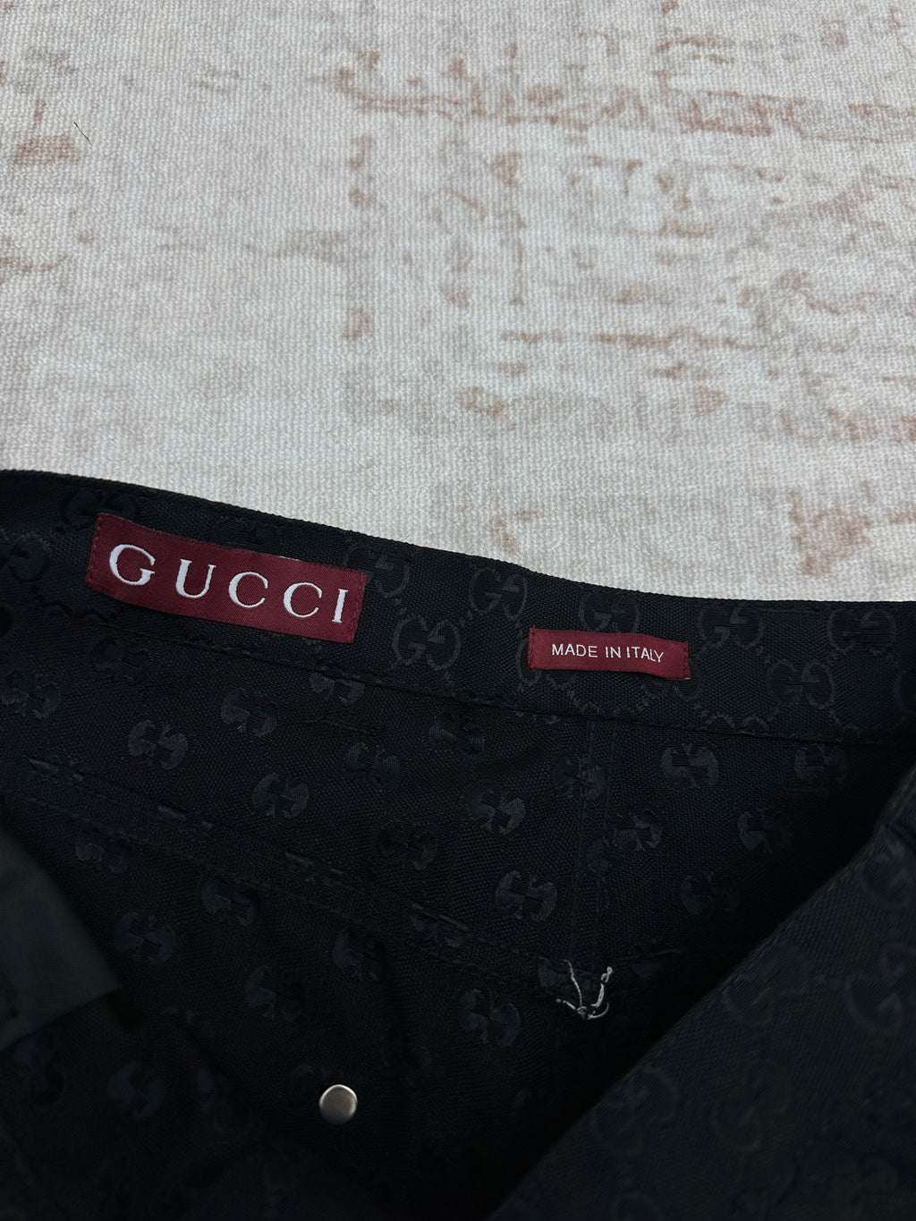 Gucci dark navy shorts with GG-style monogram pattern, interior waistband label