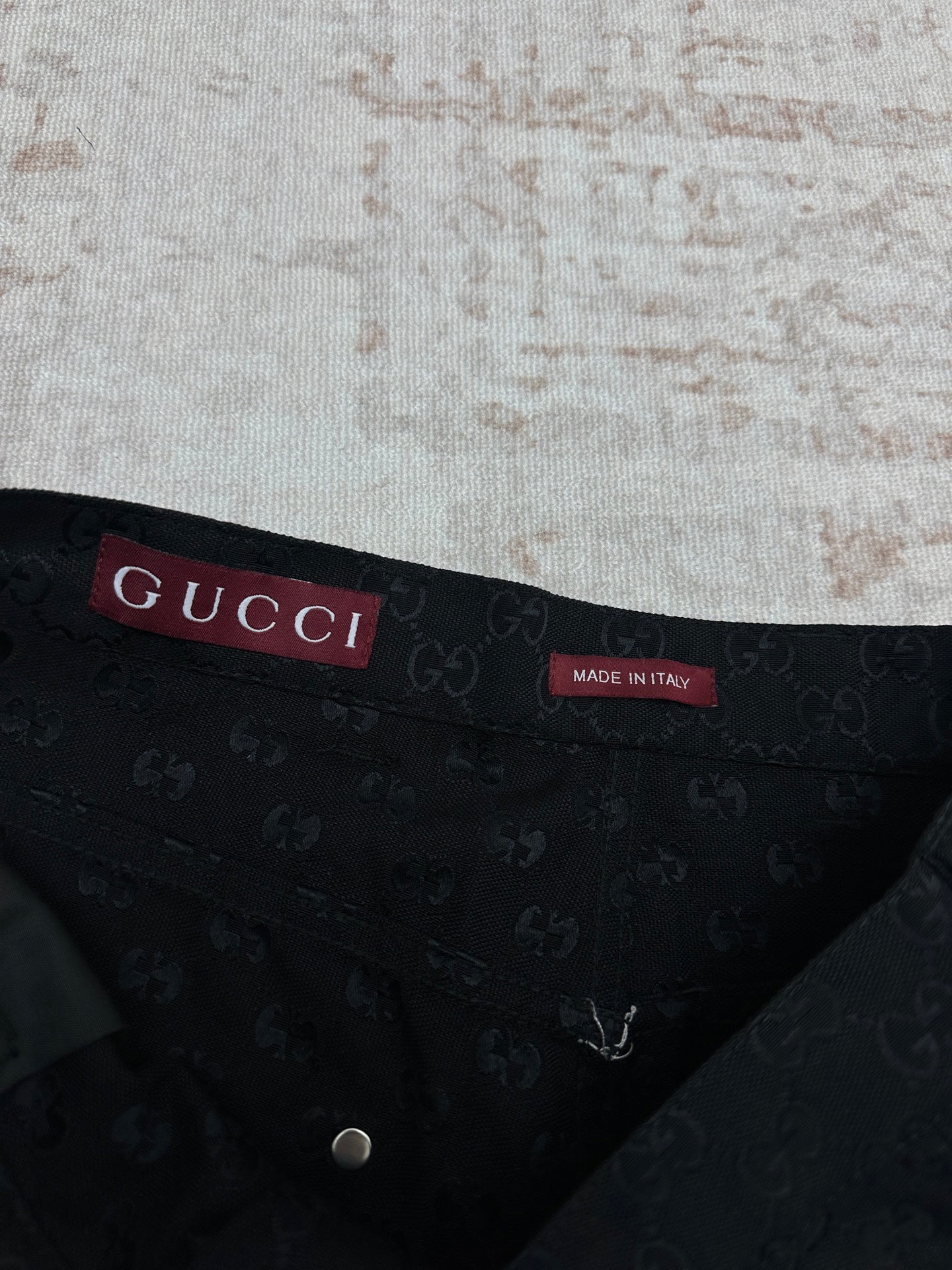 Gucci dark navy shorts with GG-style monogram pattern, interior waistband label
