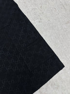Gucci dark navy shorts with GG-style monogram pattern, side view and tapered hem